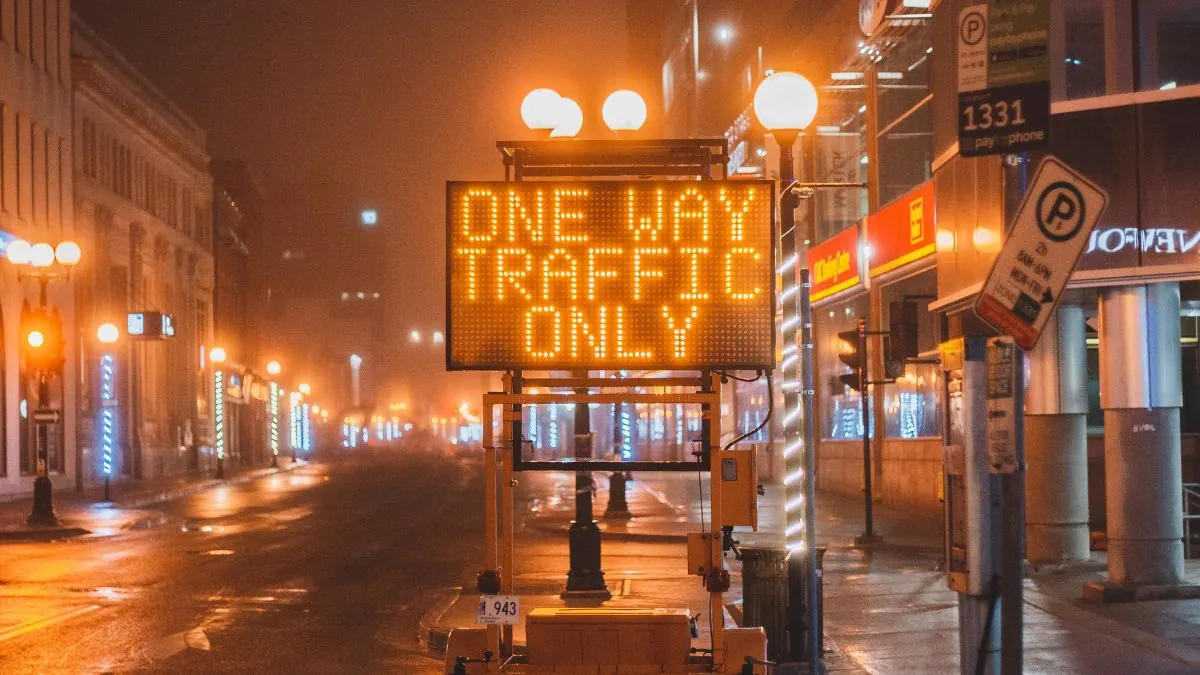 Electronic roadside message sign notifying drivers about construction traffic changes.