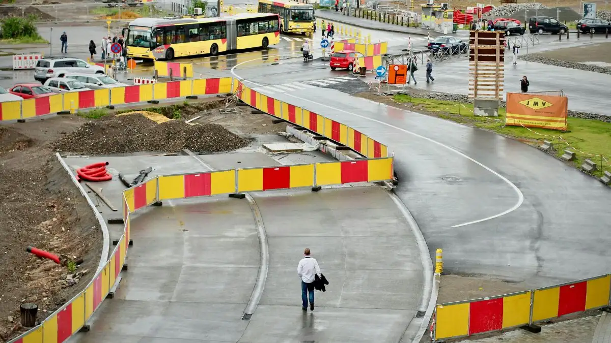 Marked pedestrian detour guiding people safely around a construction area.