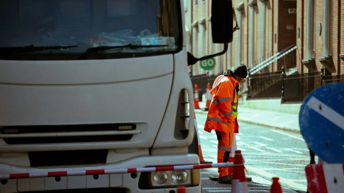 Road-work supervisor coordinating a traffic-control crew.